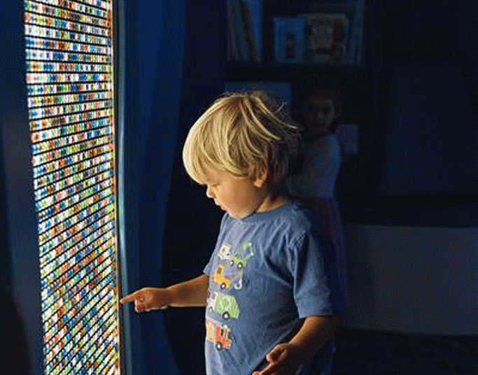 A young child at MOXI plays on a screen of brightly lit squares. (Courtesy photo)